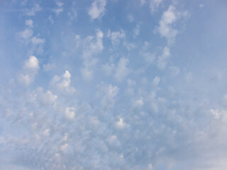 White mackerel clouds against blue sky in daylight