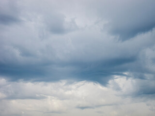 Naklejka na ściany i meble Turbulent grey clouds in daylight sky