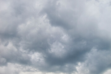 Turbulent grey clouds in daylight sky