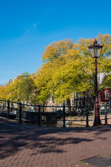 Naklejka premium autumn and city canal houses in Amsterdam 