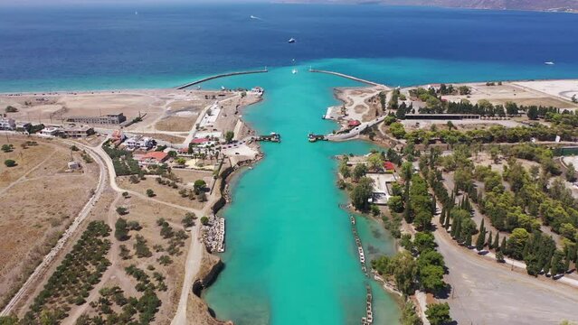 Aerial drone video of narrow Corinth canal of Isthmus from West submersible bridge and narrow opening of Corinthian gulf to Saronic gulf, Loutraki, Greece