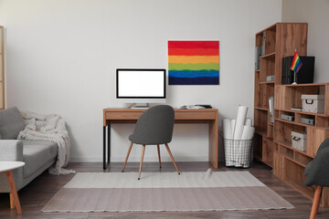 Interior of modern office with workplace, LGBT flag and painting