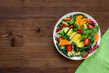 Healthy vegetarian bowl - green salad with avocado and tomatoes