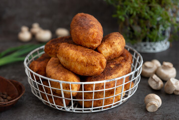 Fried patties with potatoes, mushrooms and green onions, homemade food