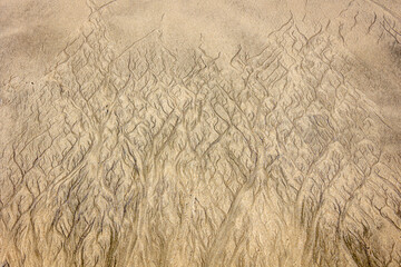 Patterns and stripes in the beach sand caused by polluted seawater, which also looks like an art form, California, USA