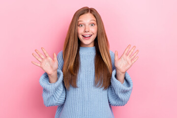 Photo of funky excited positive playful teenager schoolgirl wear blue knit jumper palms up ten...