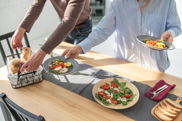 Man serving the table before breakfast