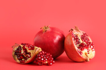 Fresh pomegranates on red background