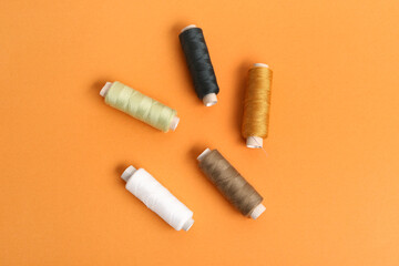 Set of thread spools on orange background