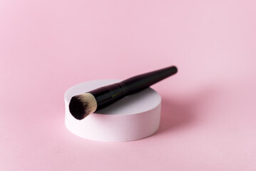 Make up Brush on White Round Pedestal Pink Background Minimal Make Up Concept Horizontal