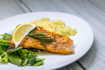 grilled salmon served with couscous and vegetables salad