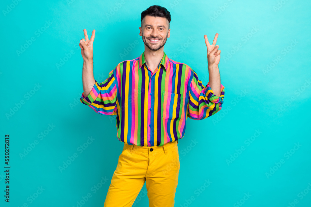 Poster portrait of nice handsome positive guy with brunet haircut wear colorful shirt showing v-sign symbol