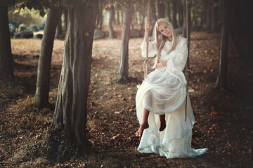 Beautiful blonde hair woman on a swing