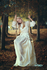Vintage bride thinking on a swing