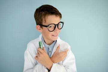 young cool boy ,with big massive black glasses is dressed up as a mad scientist holding beaker and...