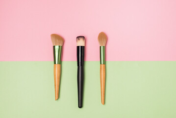 Set of Makeup Brushes on Pink Background Minimal Flat Lay Top View