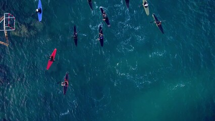 Dron footage of rowing training in the lagoon at sunset. High quality 4k footage. Team of kayak sportsmens do a traiinig on the sunset in Sicily