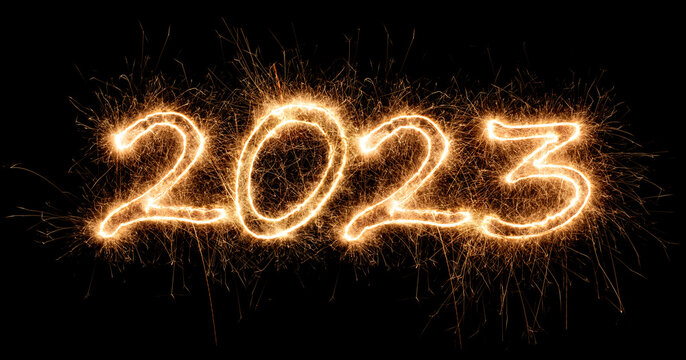 2023 sparkler golden number bright gold fireworks display black. dark celebration happy new year eve change of the year concept background