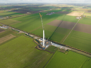 Building process of wind turbine windmill construction with cranes. Parts of the wind turbine,...