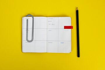 Year plan diary, jumbo big paper clip, some note daily task, memo note, pencil. writing diary,...