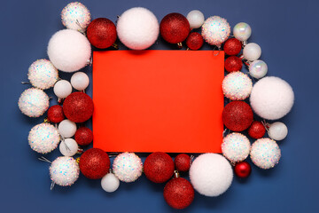 Composition with blank card and Christmas balls on blue background
