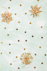 Christmas straw snowflakes decoration on green background, copy space