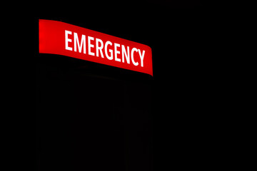 Red emergency department entrance sign at night