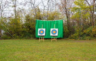 Two archery targets set on a sports field