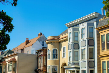 Row of modern house buildings in the downtown historic districts of San Francisco California with blue orange and beige exteriors