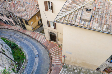 Italian Street: view from above. You can see the houses, roofs, and the road turning to the left.