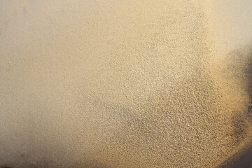 Grain glow texture blot painting stucco wall. Abstract  gold, beige, brown color stain background.