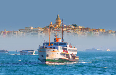Fototapeta premium Sea voyage with old ferry (steamboat) in the Bosporus - Dolmabahce Palace seen from the Bosphorus - Galata Tower, Galata Bridge, Karakoy district and Golden Horn, istanbul 
