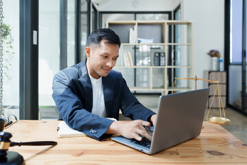 Fototapeta premium Portrait of a Asian man lawyer studying a lawsuit for a client before going to court