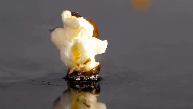 Popcorn Kernel Pops in Slow Motion, Cooks On Heat, Splits and bursts Open, close up