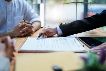 Lawyer hands important documents to couple to sign