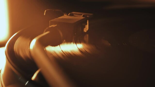 A vinyl record spins in the gramophone music player and plays an old disco. Close-up shot of retro vinyl record player