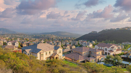 Fototapeta na wymiar Panorama Puffy clouds at sunset Suburban residences on a mountain from the view at Double Peak P