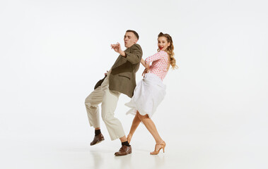 Two emotional dancers in vintage style clothes dancing swing dance, rock-and-roll or lindy hop...