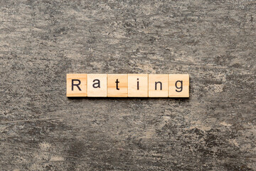 Rating word written on wood block. Rating text on cement table for your desing, concept