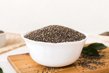 Chia seeds in bowl on colored background. Healthy Salvia hispanica in small bowl. Healthy superfood