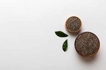 Chia seeds in bowl on colored background. Healthy Salvia hispanica in small bowl. Healthy superfood