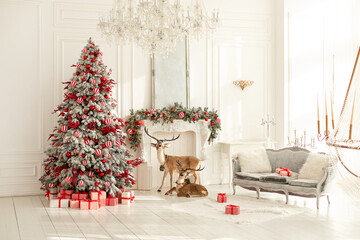 Stylish white living room interior with decorated Christmas tree, fireplace and sofa with pillows. Christmas at home. New year winter home decor. Xmas tree with lights glowing garlands and gifts	