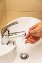 a woman washes her hands in the bath
