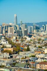 Downtown cityscape with pride flag in San Francisco California with skysrapper background and hazy sky with sprawling buildings