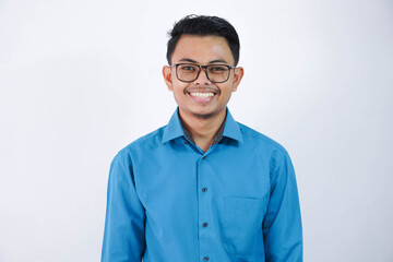 portrait smiling or happy asian young businessman with glasses standing and looking camera wearing blue shirt isolated on white background