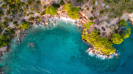 Beautiful azure blue Mediterranean beach surrounded by green trees in Croatia