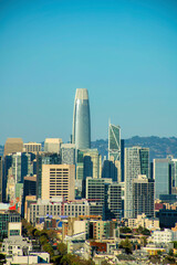 Fototapeta premium Downtown sky scrappers in late afternoon sun in the historic districts of san francisco california with buildings and mountains