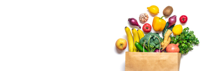 Eco friendly paper shop bag with raw organic green vegetables isolated on white background Flat lay, top view Zero waste, plastic free concept Healthy clean eating diet and detox, agriculture concept