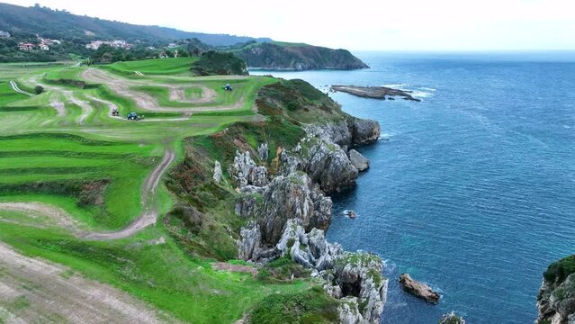 Landscape of cliffs and mowing meadows on the Am&iacute;o Coast. Aerial view from a drone. Pechon town. Cantabria. Spain. Europe.