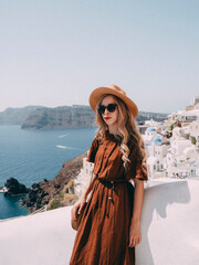 Woman enjoying the beautiful view of Santorini coast 